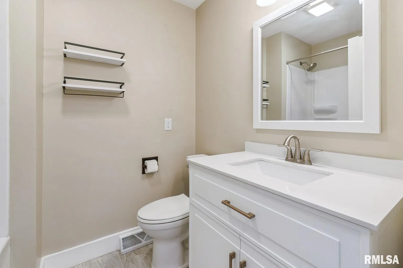 Clean, modern bathroom renovation with white vanity